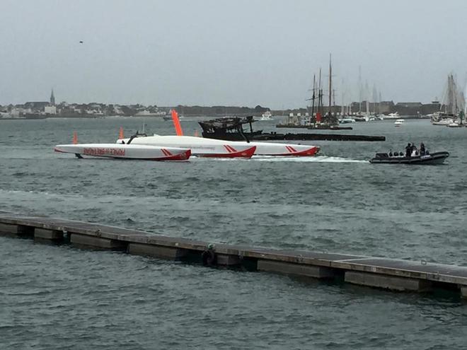 The capsized 80ft Ultime trimaran Prince de Bretagne is towed into port - Vincent Marsaudon  © SW