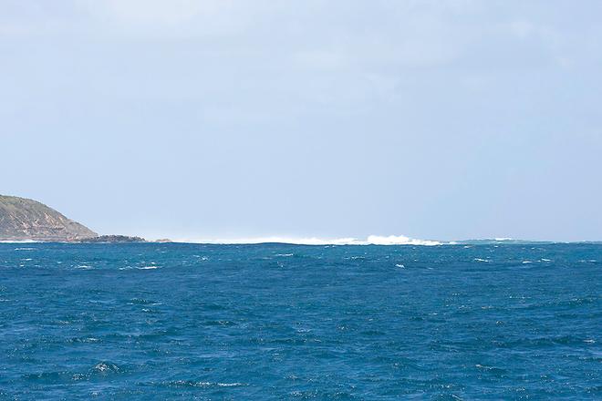 Standing waves appear over dangerous areas, even on relatively benign days like this. ©  John Curnow