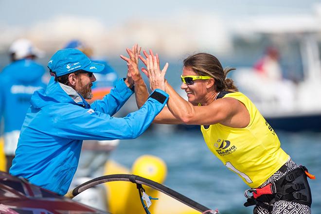 Bryony Shaw celebrates World Cup victory with coach Barrie Edgington. © Richard Langdon/British Sailing Team