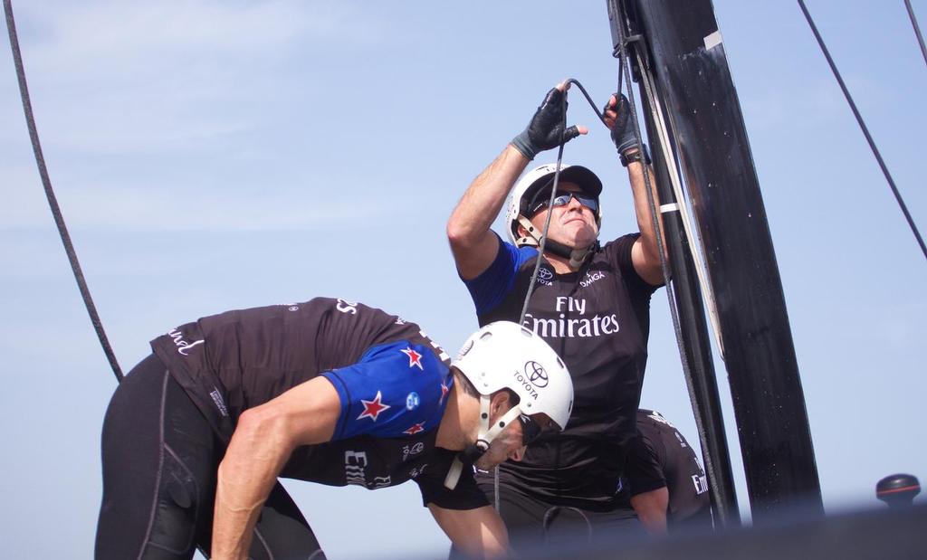 28/2/16 Ray Davies pulls up the daggerboard onboard  during sailing on race day two of Louis Vuitton America's Cup World Series Oman photo copyright Hamish Hooper/Emirates Team NZ http://www.etnzblog.com taken at  and featuring the  class