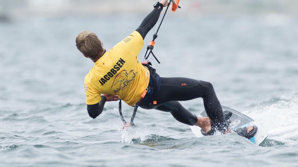 24th June 2015. Gothenburg, Sweden. Kitesurfer Nick Jacobsen jumps from the top of Abu Dhabi Ocean Racing's mast. ©  Ian Roman / Abu Dhabi Ocean Racing