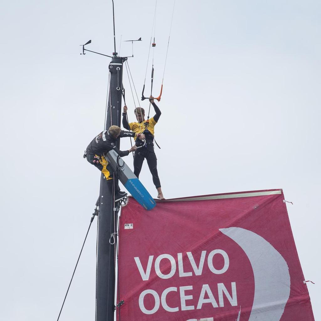 24th June 2015. Gothenburg, Sweden. Kitesurfer Nick Jacobsen jumps from the top of Abu Dhabi Ocean Racing's mast. ©  Ian Roman / Abu Dhabi Ocean Racing