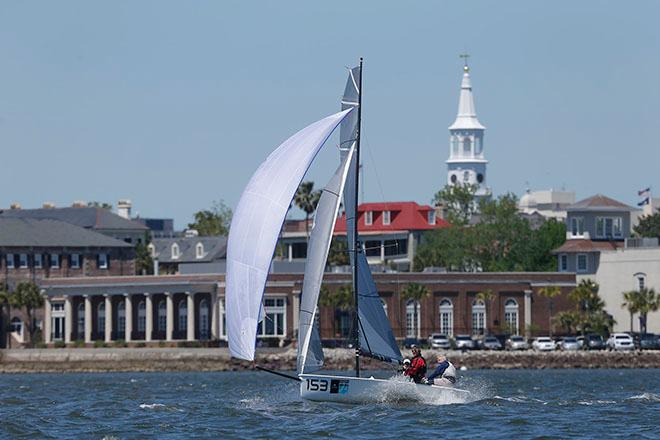 The lightest and smallest boat in Sperry Charleston Race Week 2016, the VX One Victory leaps out of the water on a plane as she passes downtown Charleston © Tim Wilkes