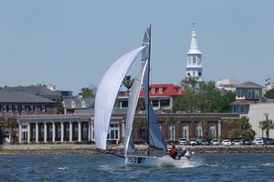 The lightest and smallest boat in Sperry Charleston Race Week 2016, the VX One Victory leaps out of the water on a plane as she passes downtown Charleston photo copyright Tim Wilkes taken at  and featuring the  class