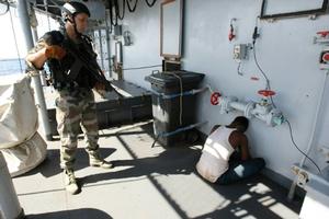 A French soldier guards a suspected Somali pirate on board the French warship ``Le Nivose`` in 2009 photo copyright Pierre Verdy (AFP/File) taken at  and featuring the  class