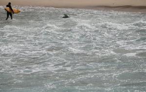 A surfer walks out of the ocean on Ipanema beach in Rio de Janeiro, Brazil, June 9, 2016. photo copyright Reuters / Sergio Moraes taken at  and featuring the  class