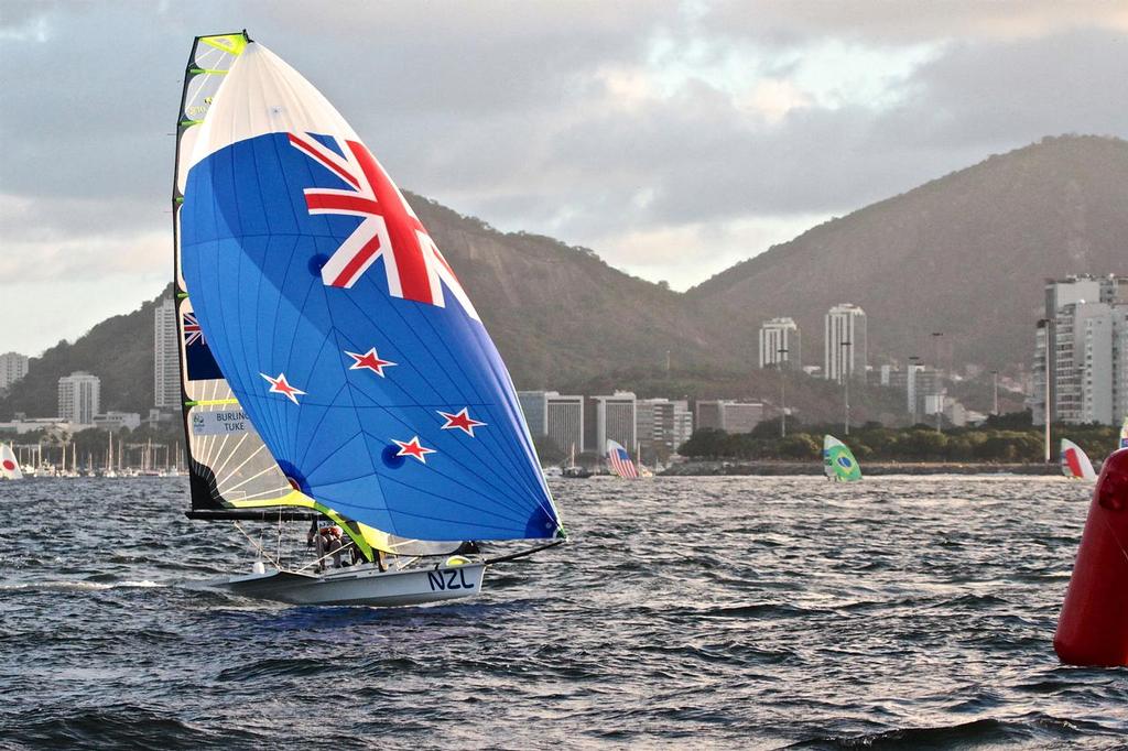 Peter Burling and Blair Tuke cross the finish line against the backdrop of Guanabara Bay, Race 2, 49er Mens photo copyright Richard Gladwell www.photosport.co.nz taken at  and featuring the  class