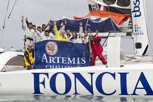 Artemis Challenge 2012 - Foncia celebration – The Foncia crew celebrate their record breaking race around around the island after completing and winning the Artemis Challenge 2012 in just 2hours, 21minutes and 25seconds. Team Foncia: Michel Desjoyeaux, Antoine Carraz, Julien Falxa, Thierry Chabagny, Alban Rossolin, Nicolas Texier, Sir Robin Knox Johnston, Ian Walker, James Boyd and Denis Juhel photo copyright Lloyd Images taken at  and featuring the  class
