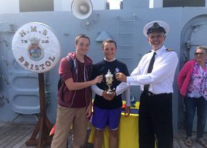 L to R: Tom Wilkinson and Frank Leslie receive the HMS Bristol Trophy from Lieutenant Commander David Price Commanding Officer HMS Bristol photo copyright Portsmouth Sail Training Trust taken at  and featuring the  class