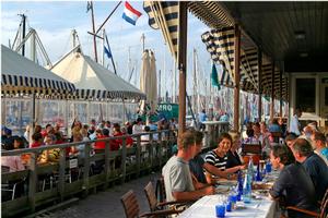 Pepole enjoying their meals from the terraces at the marina of scheveningen photo copyright Den Haag Marketing/Theo Bos taken at  and featuring the  class