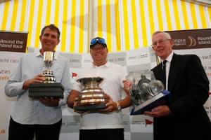 Lloyd Thornburg (centre) and his co-helm Brian Thompson (left) are pictured with Rear Commodore Peter Bingham and their fantastic collection of trophies after their stunning and record-breaking Race on Phaedo^3. - 2016 J.P. Morgan Asset Management Round the Island Race photo copyright Patrick Eden taken at  and featuring the  class