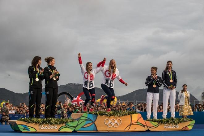 Hannah Mills and Saskia Clark (GBR) arrive on the podium for their gold medals - Rio 2016 Olympic Sailing Competition &copy; Matias Capizzano http://www.capizzano.com