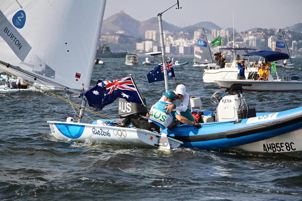 Tom Burton (AUS) greets his coach after winning the Gold medal in the Mens Laser class - 2016 Olympics photo copyright Richard Gladwell www.photosport.co.nz taken at  and featuring the  class