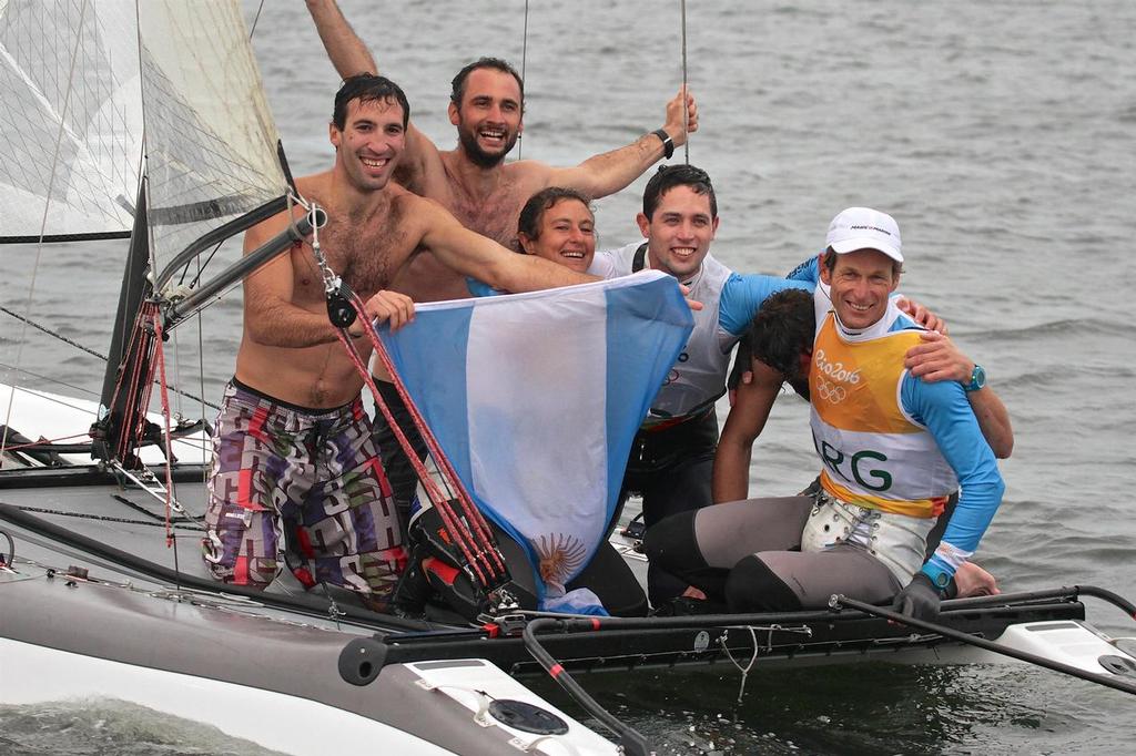 Swimmers including Santiago's two sons from the 49er class, come out to Santiago Lange and Cecilia Saroli after their Gold medal win in the Nacra17 class. Medal race 2916 Summer Olympics photo copyright Richard Gladwell www.photosport.co.nz taken at  and featuring the  class