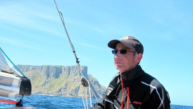 Michael Denney on the helm of Wild West with Tasman Island astern. - TasPorts Maria Island Yacht Race © Michelle Denney