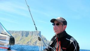 Michael Denney on the helm of Wild West with Tasman Island astern. - TasPorts Maria Island Yacht Race photo copyright Michelle Denney taken at  and featuring the  class