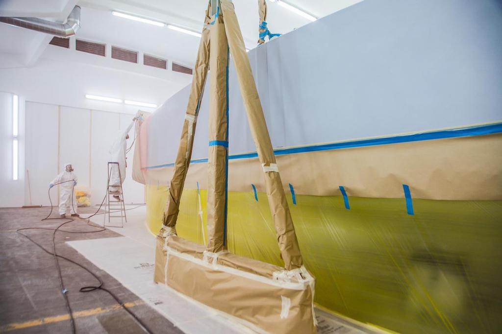 Dongfeng, the first boat into re-fit, gets its iconic colours re-applied to the hull in the Boatyard, Lisbon. ©  Amalia Infante / Volvo Ocean Race