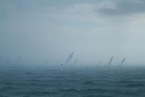 The fleet disappearing into the rain. - Mercedes Benz Mornington Couta Boat National Championships photo copyright  Alex McKinnon Photography http://www.alexmckinnonphotography.com taken at  and featuring the  class