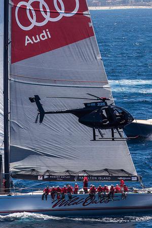 His signature shot - Wild Oats XI and a chopper. - 2016 Rolex Sydney Hobart Yacht Race photo copyright Andrea Francolini taken at  and featuring the  class