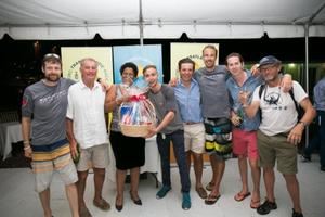 Crew of Challenger, Whitbread 60 receives a gift basket at the prizegiving - RORC Transatlantic Race photo copyright RORC/Arthur Daniel taken at  and featuring the  class