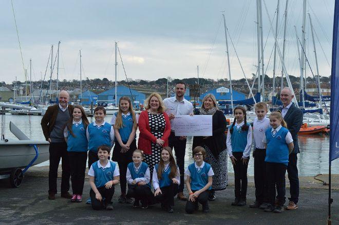 WightAID trustees Claire Willis, Brian Marriott and and Geoff Underwood present a cheque for £7,752 to UKSA CEO Ben Willows. Lanesend Primary School students who have taken part in the programme also attended with head teacher Caroline Sice. Photo by Liam Coulson from the Isle of Wight Studio School © Liam Coulson