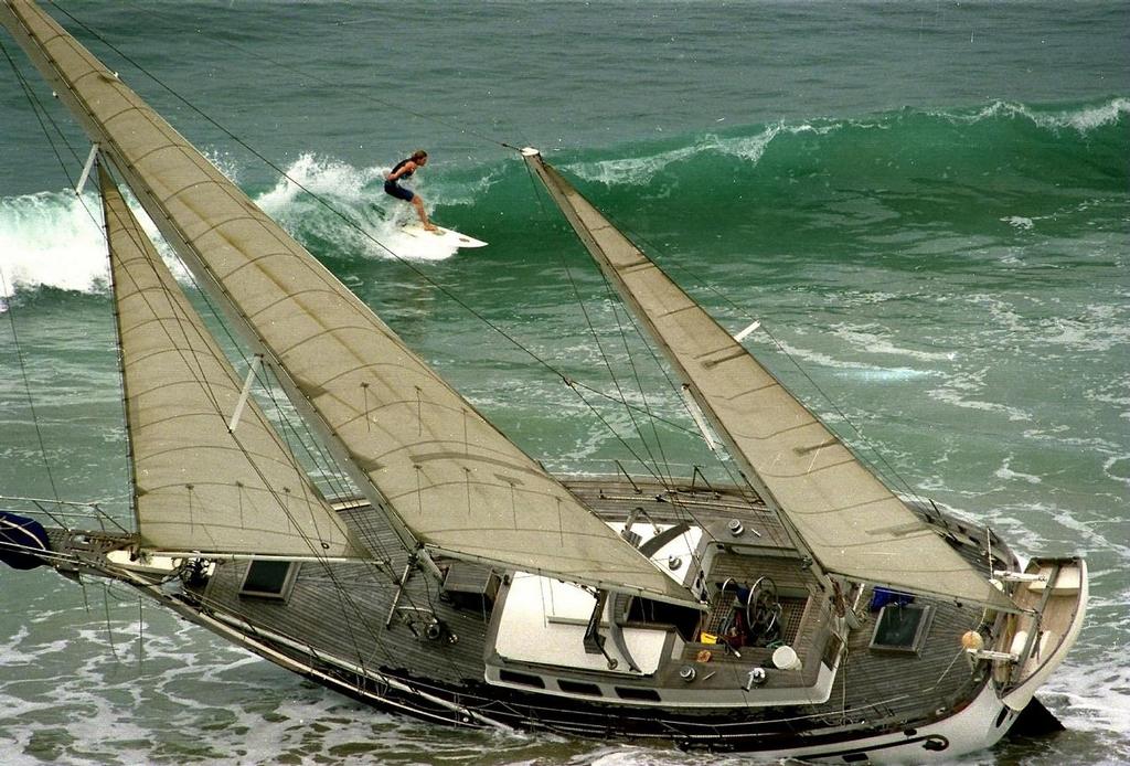 Bobby G Portfolio image - Beached yacht and surfer. © Bob Grieser/Outside Images www.outsideimages.com