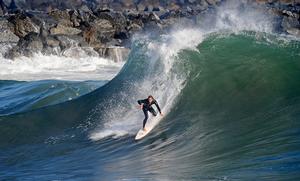 NEWPORT BEACH, CA - SEPTEMBER 01:  A surfer rides a high wave at The Wedge on September 1, 2011 in Newport Beach, California. Waves measuring up to 20 feet pounded the beach. A winter storm off the coast of Australia and New Zealand brought unusually high surf to the Southern California beaches.  (Photo by Kevork Djansezian/Getty Images) photo copyright Getty Images taken at  and featuring the  class