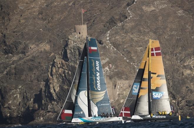 The fleet racing close to the shore and historic town of Mutrah - Extreme Sailing Series © Lloyd Images http://lloydimagesgallery.photoshelter.com/