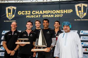 Oman Air's winning crew with Rashid Al Kindi, Chairman of the Oman Sailing Committee and Vice President of the Asian Sailing Federation - GC32 Championship photo copyright Jesus Renedo / GC32 Championship Oman taken at  and featuring the  class