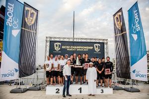 The podium with Rashid Al Kindi (see his title left) and David Graham, CEO of Oman Sail - GC32 Championship photo copyright Jesus Renedo / GC32 Championship Oman taken at  and featuring the  class