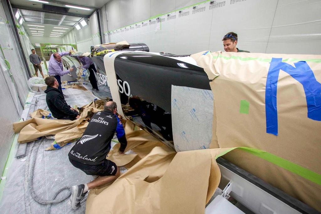 Emirates Team New Zealand's America's Cup class boat, has the finishing touches put on her at the Southern Spars composite engineering facility photo copyright Hamish Hooper/Emirates Team NZ http://www.etnzblog.com taken at  and featuring the  class