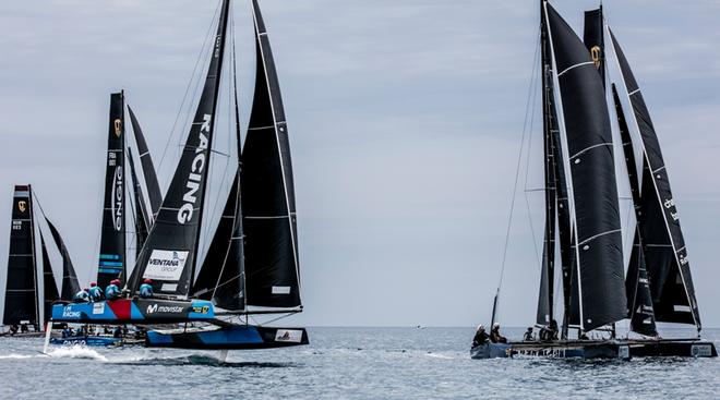 Day 3 – Movistar-Ventana Group charges through the fleet in a big gust – GC32 Villasimius Cup © Jesus Renedo / GC32 Racing Tour