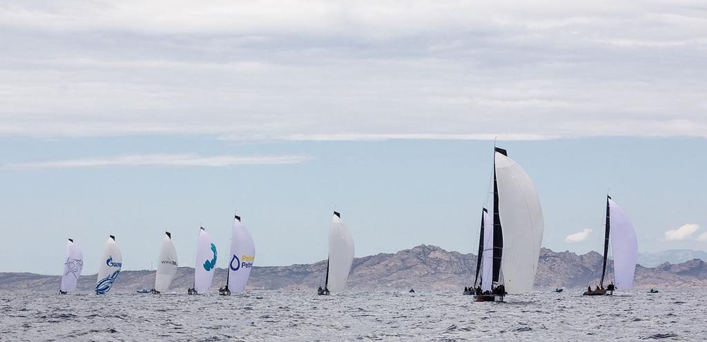 The RC44 fleet race against the backdrop of Porto Cervo © Nico Martinez/ Martinez Studio