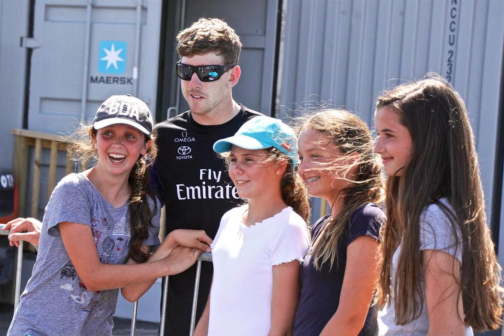 Emirates Team New Zealand's  helmsman Peter Burlings poses with fans at the fence of the team's base in Bermuda © Richard Gladwell www.photosport.co.nz