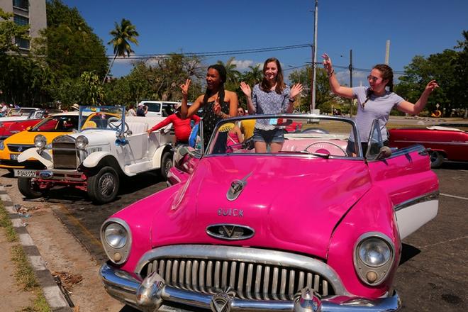 Enjoying a photo op in an antique car in downtown Havana ©  Mark Russell