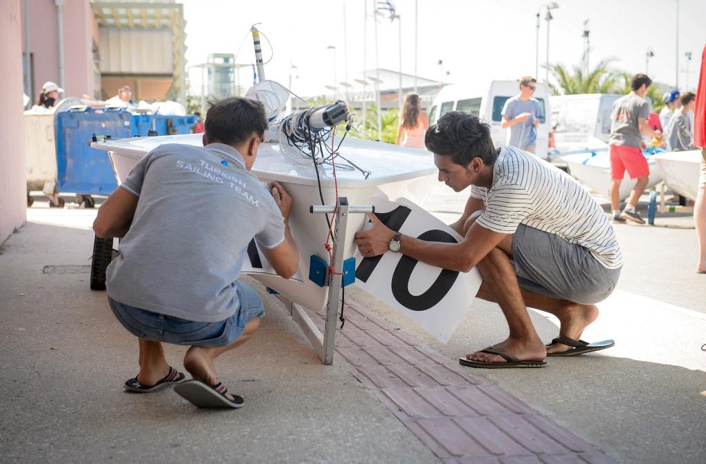 Applying bow stickers - 2017 420 Open European Championships © Nikos Alevromytis http://www.470.org