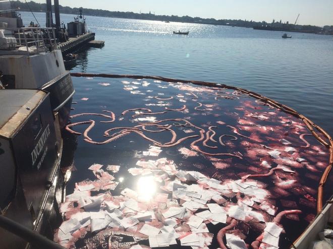Boom and absorbent pads deployed in New Bedford Harbor, Wednesday, Aug. 16, 2017. The Coast Guard and Massachusetts Department of Environmental Protection were called to the scene fishing vessel Challenge sank at the pier and started discharging fuel. © Lt. Lynn Schrayshuen