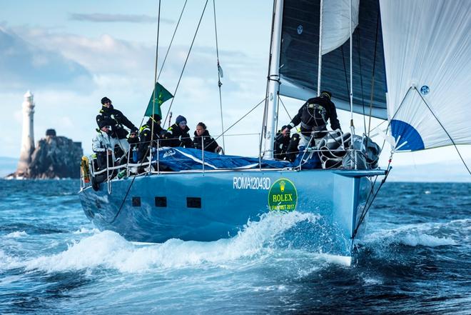The Italian crew of Ars Una concentrates on keeping the spinnaker filled as they leave the Fastnet Rock in their wake Rolex Fastnet Race © Quinag