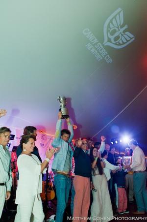(left) Seumas Meharg, captain of Bequia, raises the Candy Store Cup while tactician Tom Whidden gives a thumbs up photo copyright  Matthew Cohen taken at  and featuring the  class