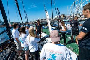 Team Oman Sail show the EMCT crew around their GC32 at the Extreme Sailing Series photo copyright Ellen MacArthur Cancer Trust taken at  and featuring the  class