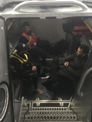 A Coast Guard Station Castle Hill boat crew member sits with the survivors from a capsized catamaran off Jamestown, Rhode Island, Saturday, Sept. 30, 2017. The boat crew brought the survivors and their vessel back to Dutch Harbor. photo copyright U.S. Coast Guard photo by Petty Officer 2nd Class taken at  and featuring the  class