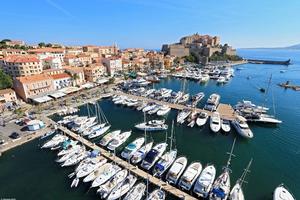 The marina at Calvi, in the shadow of the town's famous citadel. photo copyright  Sébastien Aude taken at  and featuring the  class