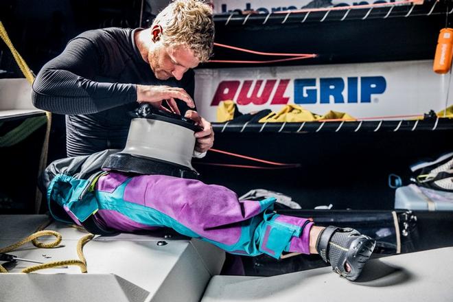 Leg 1, Day 3 – Alicante to Lisbon, onboard AkzoNobel. Danish sailor Nicolai Sehested repairs a winch – Volvo Ocean Race ©  Konrad Frost / Volvo Ocean Race