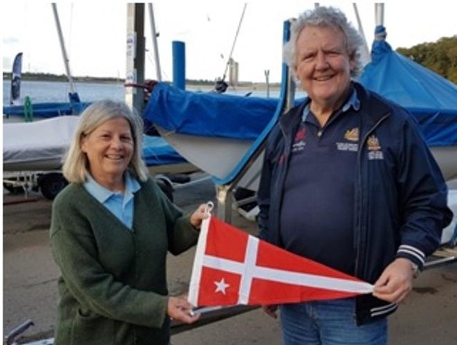 John Hassen presenting Veronique Hachez with a South of Perth Yacht Club burgee – Belgium Nationals ©  John Hassen