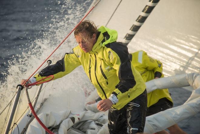 Day 8, Leg 2, Lisbon to Cape Town, Annie Lush on the foredeck with waves crashing – Volvo Ocean Race ©  Rich Edwards / Volvo Ocean Race