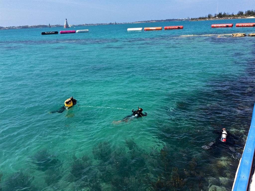 Military divers conduct a grid search outside the media theatre in Bermuda, 35th America&rsquo;s Cup photo copyright Richard Gladwell www.photosport.co.nz taken at  and featuring the  class