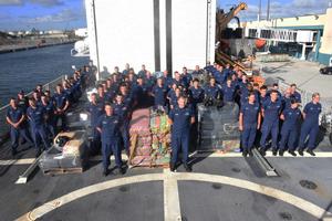 The crew of the Coast Guard Cutter Spencer stands next to approximately 10 tons of seized contraband prior to disposition at Port Everglades in Fort Lauderdale, Florida, Tuesday, Nov. 14, 2017. The fight against transnational organized crime networks in the Eastern Pacific requires unity of effort in all phases from detection, monitoring and interdictions, to prosecution. photo copyright Petty Officer Third Class Brandon Murray taken at  and featuring the  class