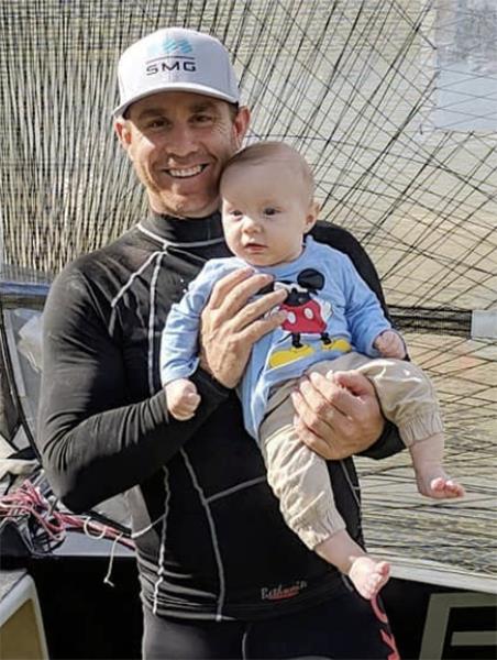 Proud father Marcus with baby Phoenix photo copyright Frank Quealey taken at Australian 18 Footers League and featuring the 18ft Skiff class