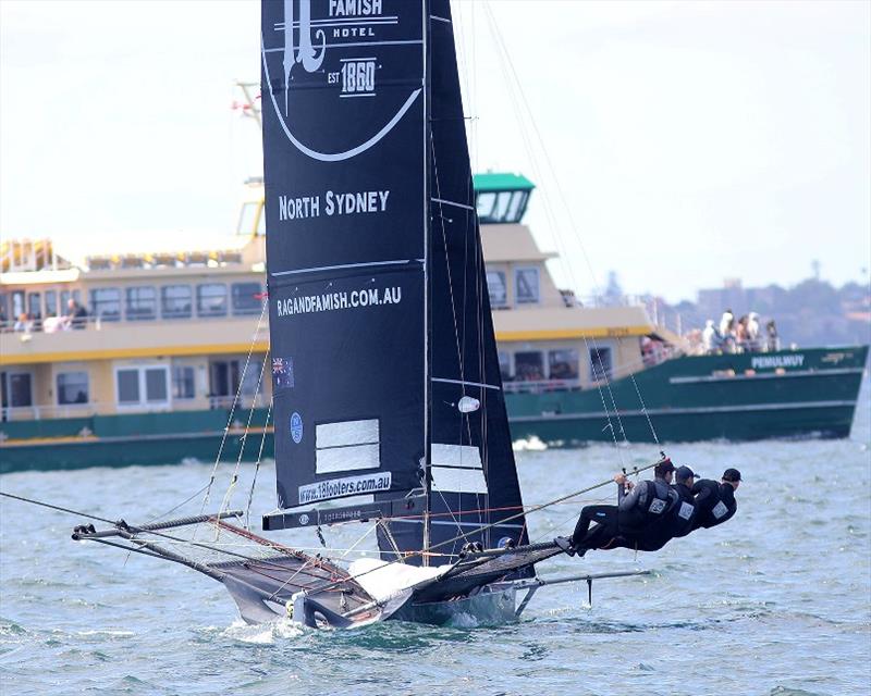 Defending champion Rag and Famish Hotel prepares to avoid a passing harbour ferry photo copyright Frank Quealey taken at Australian 18 Footers League and featuring the 18ft Skiff class