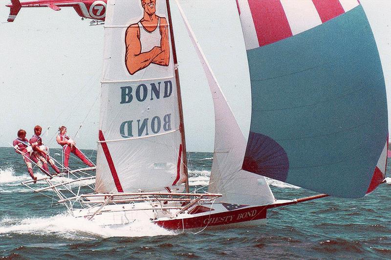 TVs Channel 7 helicopter follows Chesty Bond down the coast photo copyright Frank Quealey taken at Australian 18 Footers League and featuring the 18ft Skiff class